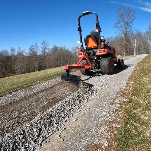 Grading-driveway-gravel-with-Utility-tractor-blade.webp