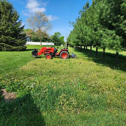 Tractor-with-rotary-tiller-attachment.webp